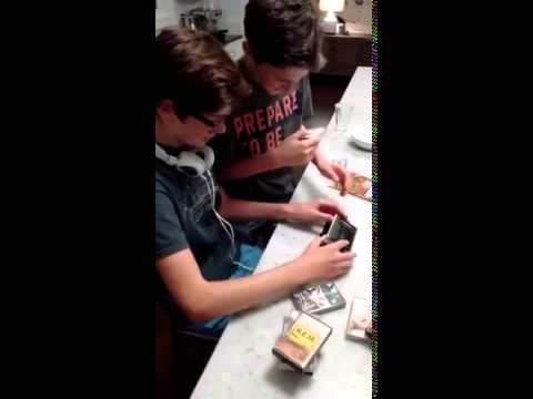 Two kids trying to figure out how to use a Walkman