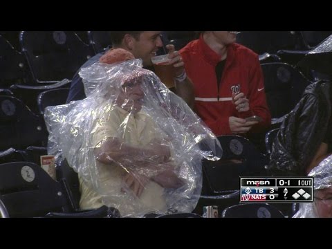 Nats fan struggles to put on rain poncho