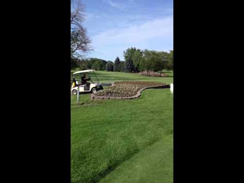 Golf cart jumps flower bed and lands hard